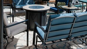 An outdoor patio area with a round table, chairs, and a hanging chair. - Luxurious, downtown loft with a warm, family feel (Sheridan)