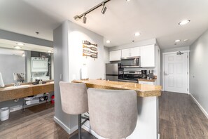 Enjoy cooking in this well-equipped kitchen with oven, microwave, and refrigerator.