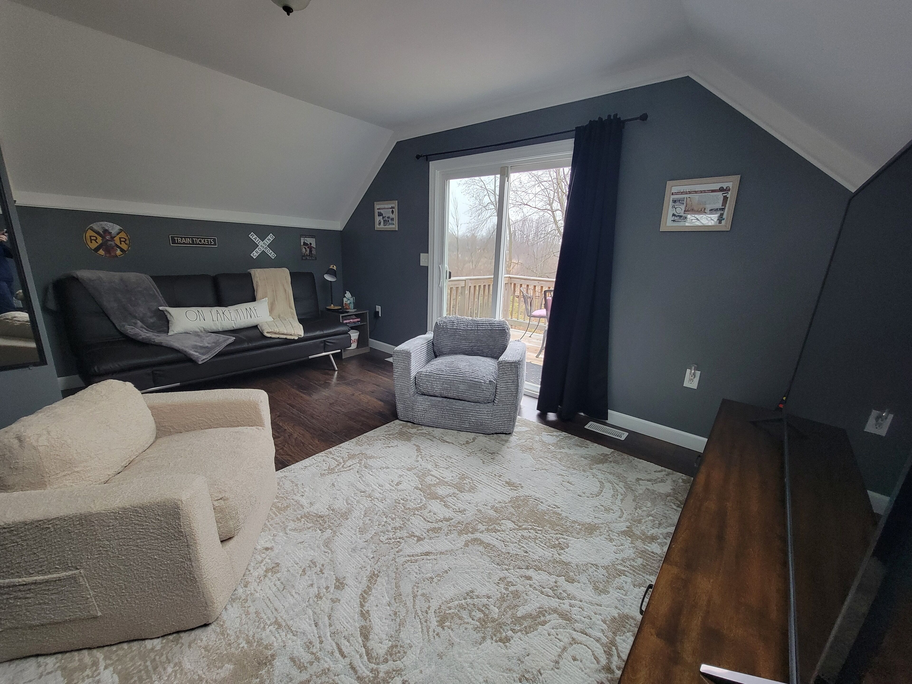Cozy Theater/game room upstairs above the bar with a deck off of it. 