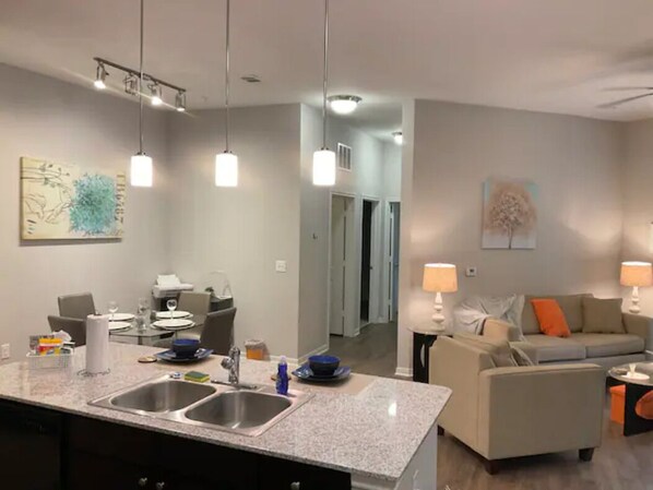 Enjoy a comfortable stay in this well-appointed living space with a kitchen, dining area, and cozy seating.