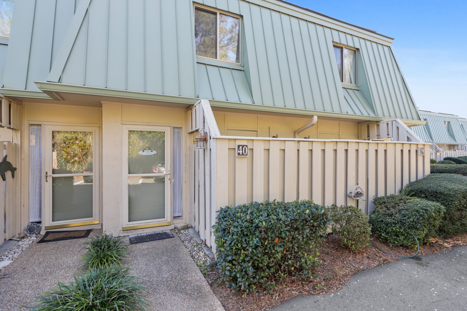 A two-story residential building with a light green exterior, numbered 40 and 39.