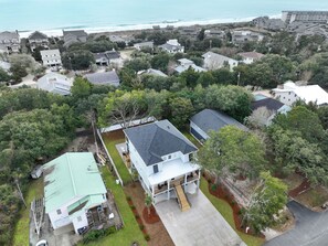 An aerial view of a residential area with houses, a dock, and a view of the ocean. - Litchfield Home w/ Private Pool for Large Groups (Litchfield by the Sea)
