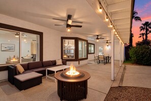 An outdoor patio area with a fire pit, seating, and ceiling fans. - Sereno- North Scottsdale- Private Pool & Games! (Scottsdale)