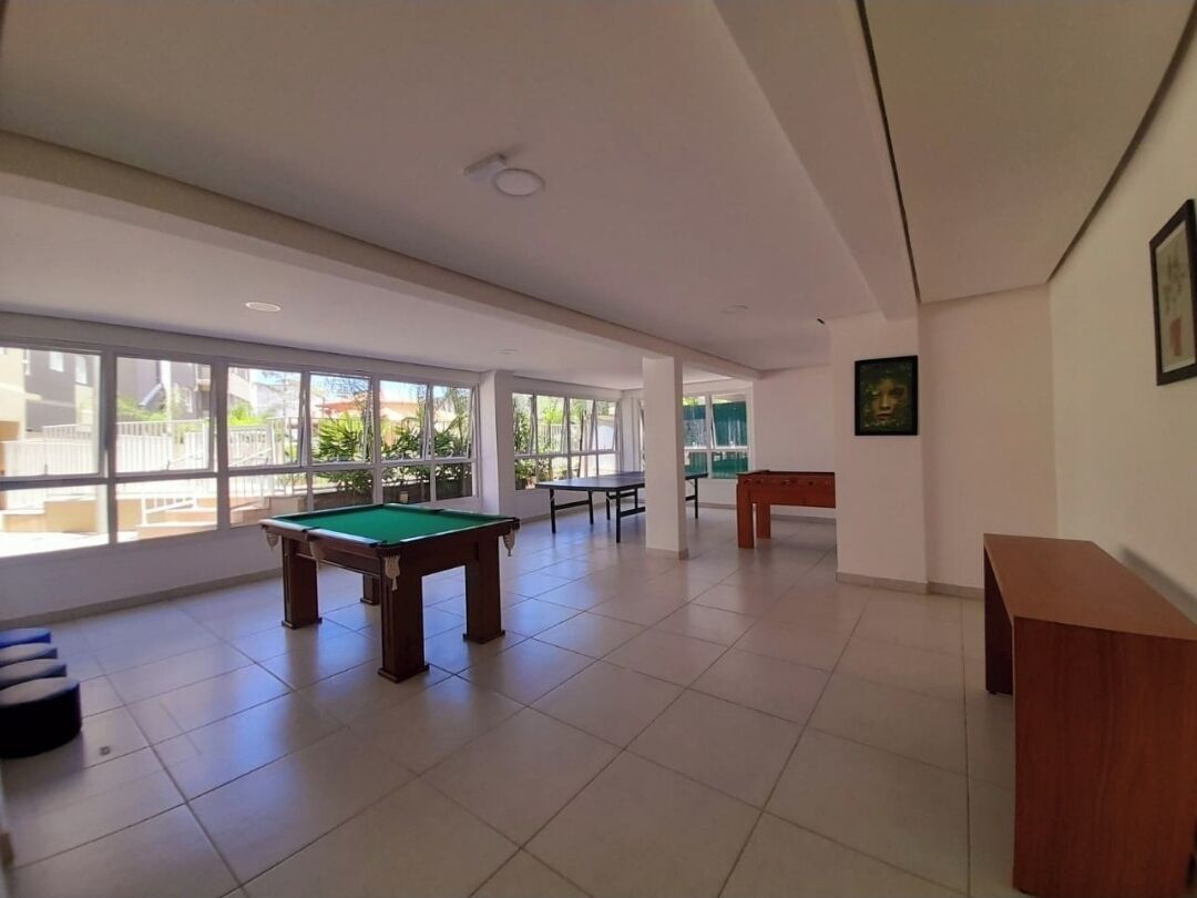 A spacious indoor area with a pool table, a ping pong table, and a foosball table.