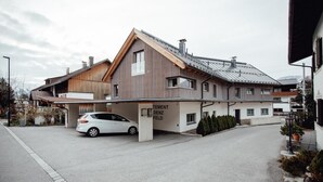 Een modern gebouw met een auto ervoor, een bord waarop 