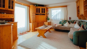 Una sala de estar acogedora con armarios de madera, un sofá y una mesa de centro.