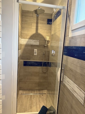 Shower, hair dryer, towels, toilet paper