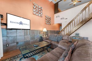 A living room with a sofa, coffee table, and a television displaying 'RENTBRJASON.COM'. - Best-View 3-Bedroom Condo, Close to Silver Dollar City with Free Tickets & Outdoor Pool (Branson)