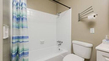 Bathtub, towels, soap, toilet paper