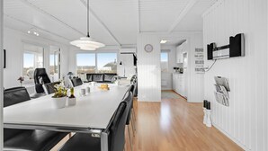 A modern, well-lit room with a long dining table, black leather chairs, and a white ceiling. - Amazing home in Vinderup with WiFi (Vinderup)