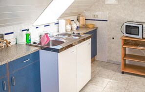 Fridge, microwave, coffee/tea maker, cookware/dishes/utensils