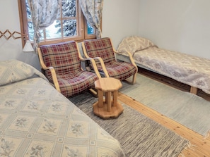 A cozy room with two sofas, a small wooden stool, and a bed with patterned bedding. - Vacation home Koivu by Interhome (Kuusamo)