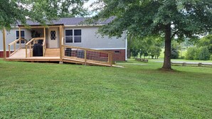 A house with a wooden deck, a front door, and a garage. - The DW - Spacious and Cozy (Columbia)