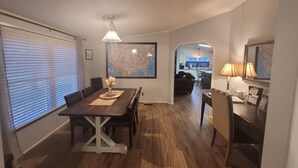 A dining area with a wooden table, chairs, and a map on the wall. - The DW - Spacious and Cozy (Columbia)