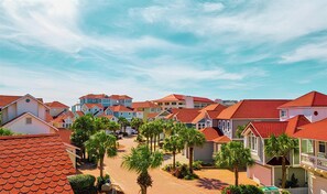 A residential area with houses featuring red roofs and a clear sky.