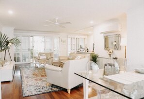 Relax in a spacious living area with a comfortable sofa and armchairs, perfect for unwinding.