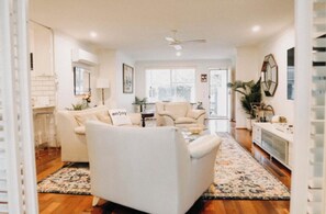 Relax in this spacious living area with a sofa, armchairs, and dining table for two.