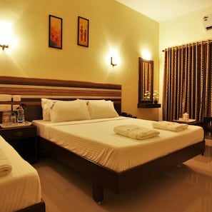 A hotel room with a large bed, two bedside tables, a nightstand, and a mirror.
