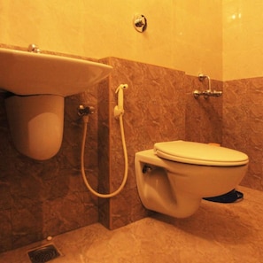A bathroom with a toilet, a sink, and a shower.