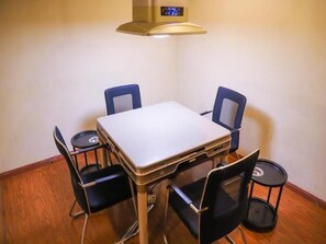 A small dining area with a square table and four black chairs. - Greentree Inn Hefei Shushan District West Wangjiang Road Qianshan Road Express Hotel (Hefei)