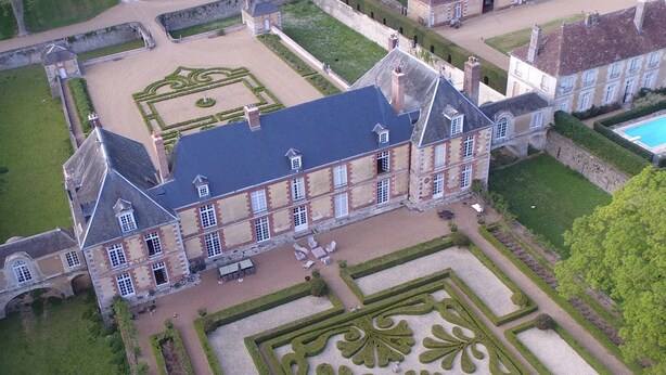 A large, historic building with symmetrical gardens and a central courtyard. - 18th century castle (Saint-Luperce)
