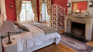 A bedroom with a bed, a fireplace, and curtains. - 18th century castle (Saint-Luperce)