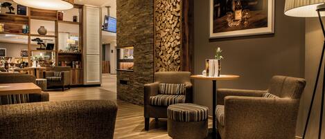 A modern interior with a seating area, a wooden wall, and a framed picture on the wall.