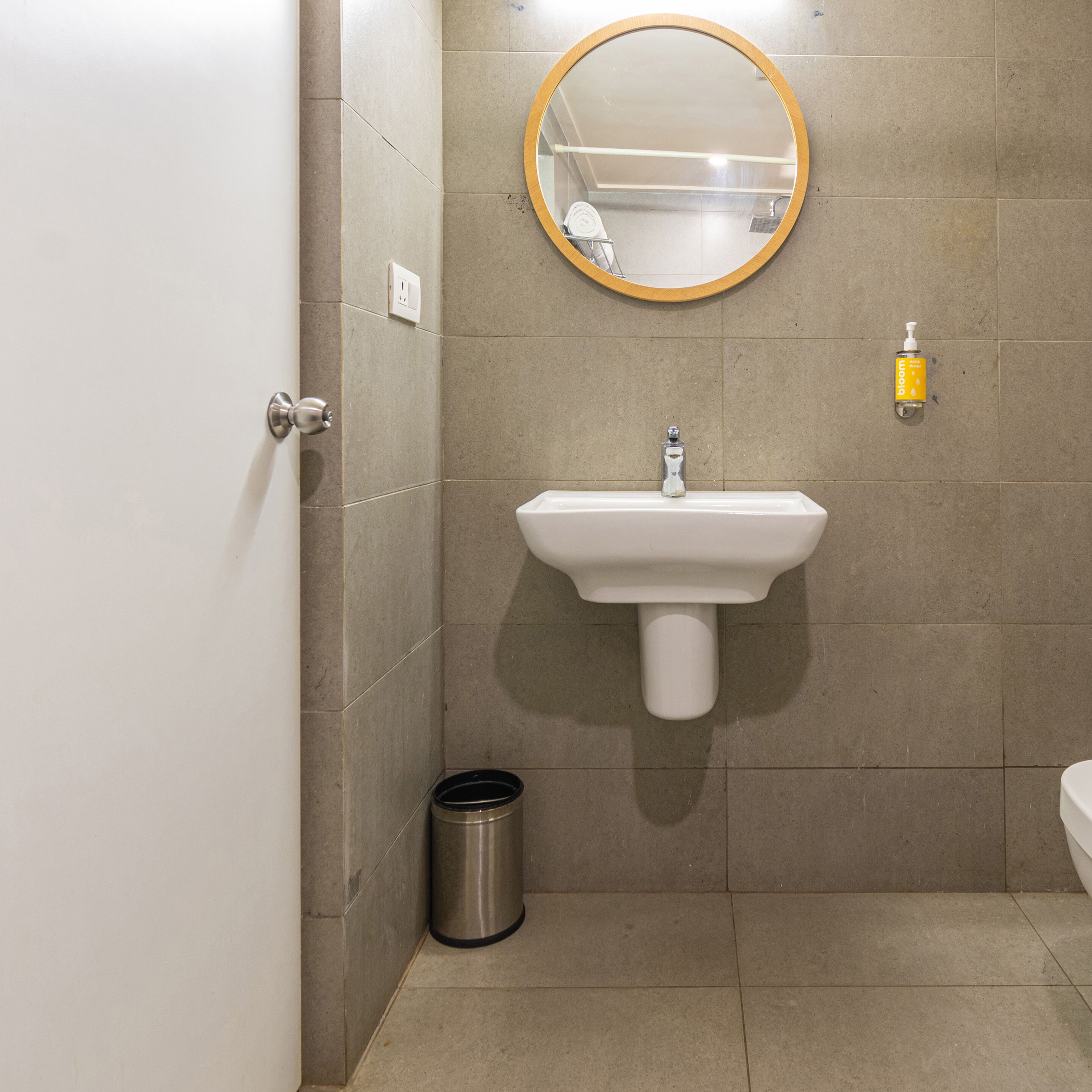 A bathroom with a sink, mirror, and toilet.
