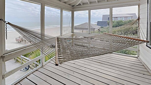 A hammock on a wooden deck with a view of the beach and ocean. - Ocean & Creekfront: Selah mid Island, Porches, Decks, Dock (Pawleys Island)