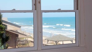 A window with a view of the ocean and a beach area. - Ocean & Creekfront: Selah mid Island, Porches, Decks, Dock (Pawleys Island)