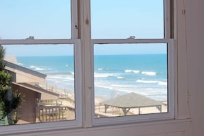 A window with a view of the ocean and a beach area. - Ocean & Creekfront: Selah mid Island, Porches, Decks, Dock (Pawleys Island)