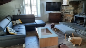 A modern living room with a sectional sofa, a coffee table, a fireplace, and decorative animal figures.