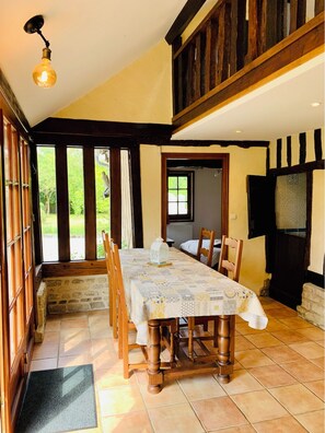 Enjoy meals in this cozy dining area with a long table and comfortable seating for four.
