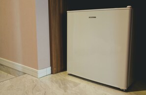 A small, white refrigerator with the brand name "IRIS OHYAMA" on the top.