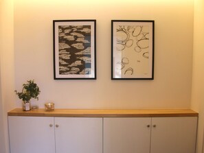 Two framed artworks on a wall above a wooden counter with cabinets below. - Guest House Paper Moon Building B No Smoking / Minamitsuru-gun Yamanashi (Minamitsuru-gun)