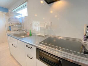 Enjoy cooking in this well-equipped kitchen with an oven, sink, and ample cabinetry.