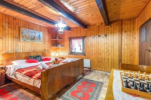 A wooden room with a bed, a desk, and a chessboard. - Chalet Birchwood With Hot Tub and Sauna (Breznički Hum)