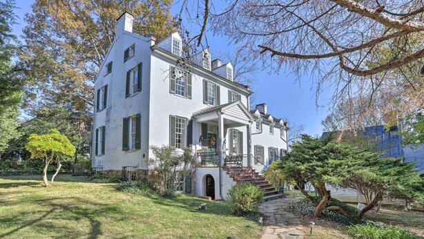 A large, white, two-story house with a covered porch and a stone pathway leading to the entrance. - Historic Warrenton Home w/ Patio & Hot Tub! (Warrenton)