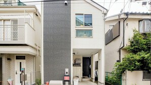 A residential building with a grey facade, a small front porch, and a visible entrance. - Private lodging in WEST TOKYO(SHINJUKU, TACHIKAWA, SANRIO, GHIBLI, MT. TAKAOetc) (Kokubunji)