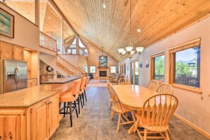 A spacious kitchen with a long island, wooden cabinets, and a dining area with a large table and chairs. - Charming, Spacious & Pet-Friendly Buena Vista Home (Buena Vista)