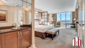 A spacious hotel room with a large bed, a sitting area, and a view of the city. - MGM Signature-11-604 Jacuzzi Studio (Las Vegas)