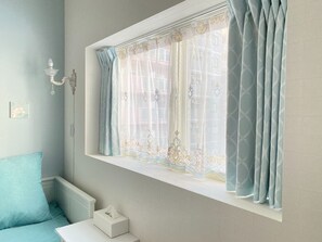 A room with a window, a white bedside table, a blue pillow, and a tissue box. - 3F Floor charter up to 11 people Newly built We / Osaka Ōsaka (Osaka)