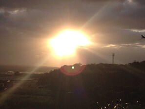 A sunset over a hilly landscape with a clear sky and a distant tower. - No smoking Single / Oshima-gun Kagoshima (Oshima-gun)