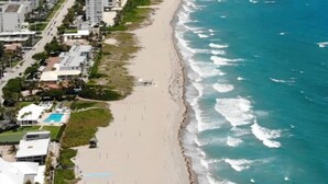 A coastal cityscape with a long sandy beach and ocean waves. - Boca Raton Home with private heated pool, close to FAU, Beach & Mizner! (Boca Raton)