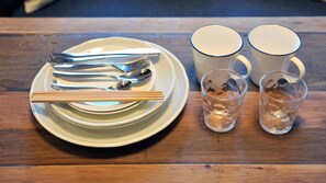 A table with a plate, chopsticks, a spoon, two cups, and two glasses. - Deluxe Room 204 - 204 / Osaka Ōsaka (Osaka)