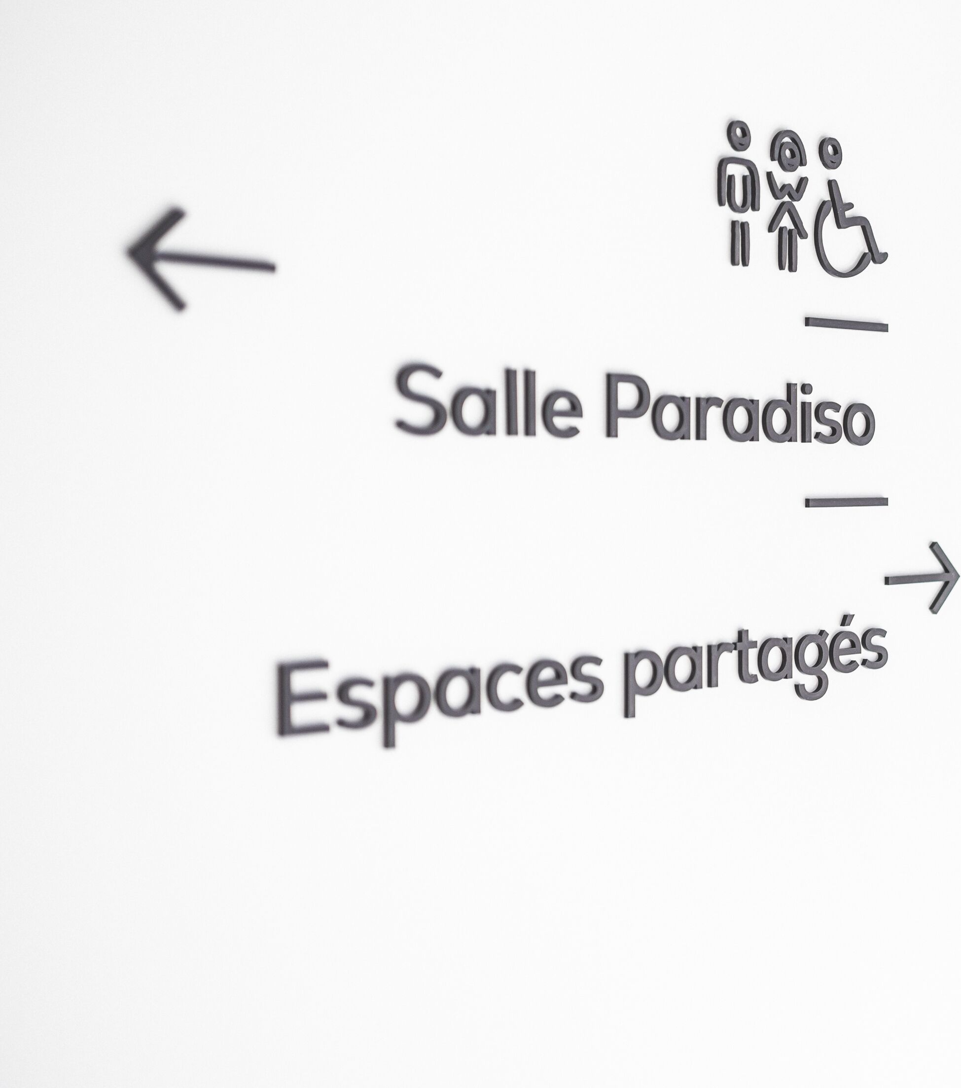 A directional sign with 'Salle Paradiso' and 'Espaces partagés' indicating shared spaces.