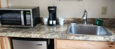 Microwave, stovetop, coffee/tea maker, cookware/dishes/utensils