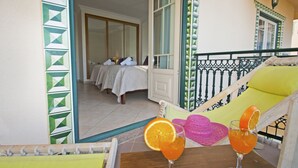 A balcony with a view of a room with a bed and a table with drinks. - Modern Apartment with Pool – Albufeira (Albufeira)