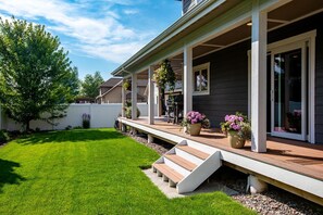 A residential house with a covered porch, a well-maintained lawn, and a small staircase leading to the entrance.