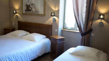 A hotel room with two beds, a nightstand, a lamp, a painting, and a window with curtains.